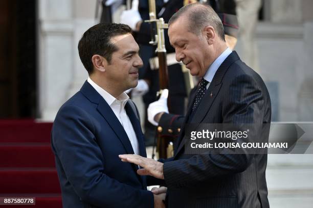 Greek Prime minister Alexis Tsipras welcomes Turkish President Recep Tayyip Erdogan before their meeting in Athens, on December 7 as part of...