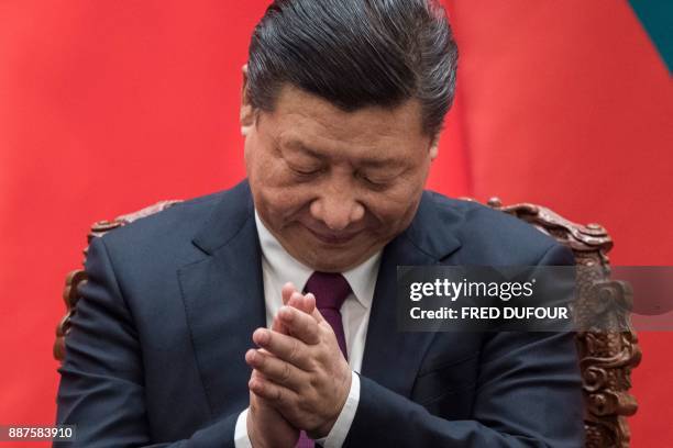 China's President Xi Jinping applauds during a signing ceremony with Maldives' President Abdulla Yameen at the Great Hall of the People in Beijing on...