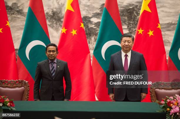 Maldives' President Abdulla Yameen stands with China's President Xi Jinping during a signing ceremony at the Great Hall of the People in Beijing on...