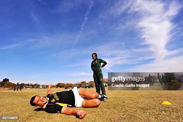 Pierre Spies carries out some stretching exercises with the assistance of physio Rene Naylor during a Springboks training session at Fourways High...