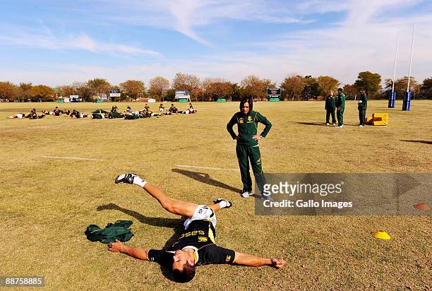 Pierre Spies carries out some stretching exercises with the assistance of physio Rene Naylor during a Springboks training session at Fourways High...