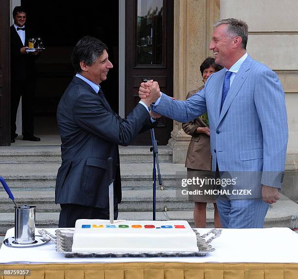 Swedish Ambassador to the Czech Republic Catherine von Heidenstam looks at Czech Prime Minister Jan Fischer shaking hands with former Czech Prime...