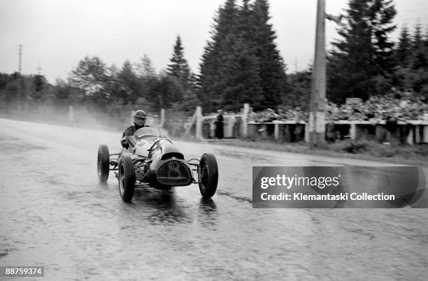 The Belgian Grand Prix; Spa-Francorchamps, June 22, 1952. It often rains at Spa, and here is Mike Hawthorn in his Cooper-Bristol passing the pits and...