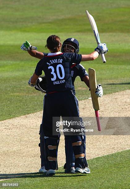 Sarah Taylor of England is congratulated by teammate Ebony Rainford-Brent after she reaching her century during the Women's One Day International...