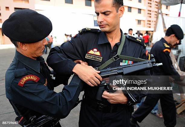 National Security Guard commando helps his commander Siddhrath Tomar adjust the belt of his MP5 gun before the inuaguration of the NSG Regional Hubin...