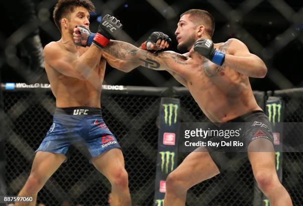 Sergio Pettis punches Henry Cejudo during the UFC 218 event at Little Caesars Arena on December 2, 2017 in Detroit, Michigan.