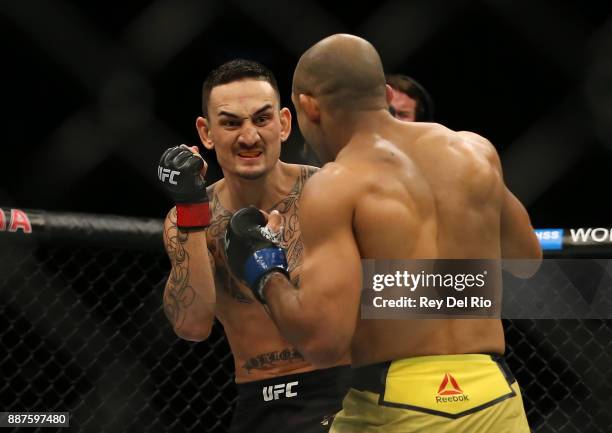 Jose Aldo punches Max Holloway during the UFC 218 event at Little Caesars Arena on December 2, 2017 in Detroit, Michigan.