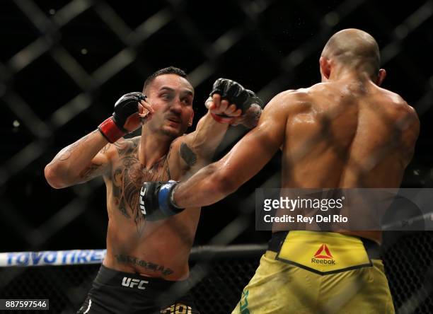 Max Holloway punches Jose Aldo during the UFC 218 event at Little Caesars Arena on December 2, 2017 in Detroit, Michigan.