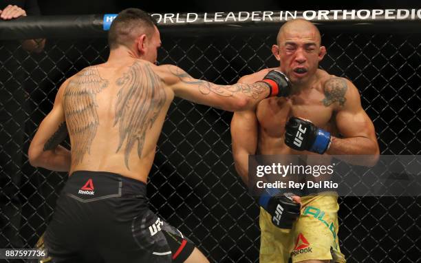 Max Holloway punches Jose Aldo during the UFC 218 event at Little Caesars Arena on December 2, 2017 in Detroit, Michigan.