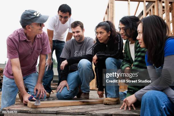 students and teacher at construction site - volunteer building stock pictures, royalty-free photos & images