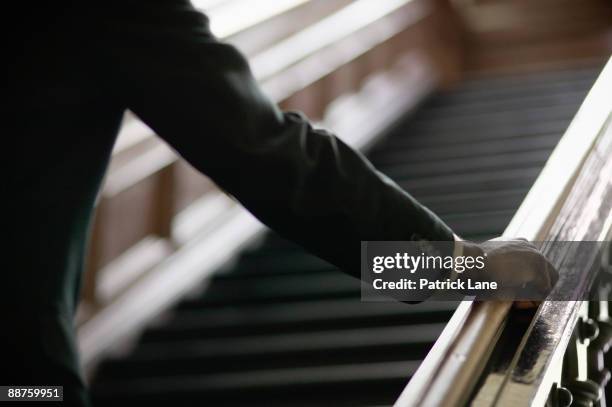 african businessman ascending staircase - railing stock pictures, royalty-free photos & images