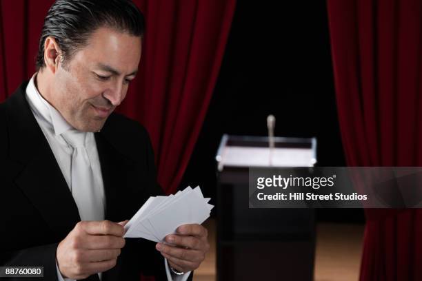 hispanic man in tuxedo reviewing notecards backstage - dinner jacket stock pictures, royalty-free photos & images