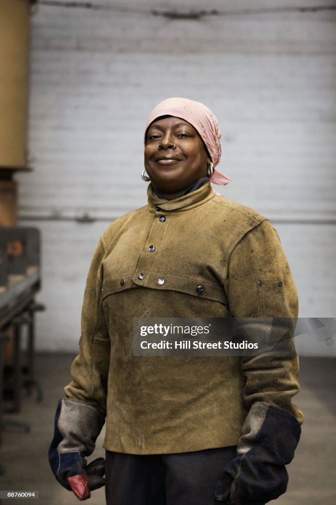 African American female welder posing