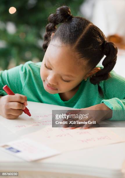 african american girl writing letter to santa claus - kid holding crayons stock pictures, royalty-free photos & images