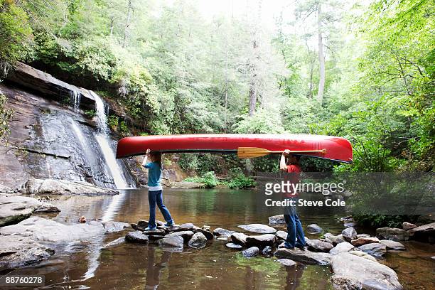 canoe couple - carrying canoe stock pictures, royalty-free photos & images