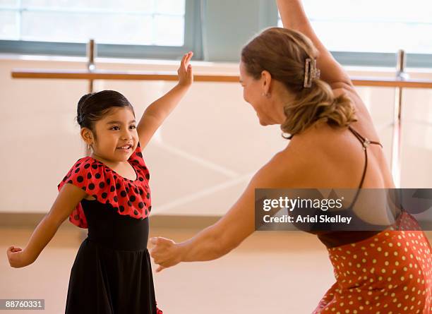 hispanic teacher and girl in dance class - dance teacher foto e immagini stock