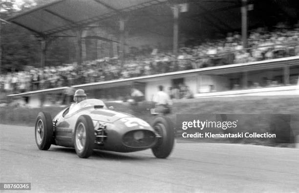 The Belgian Grand Prix; Spa-Francorchamps; June 20, 1954. Juan Manuel Fangio at speed down the hill past the pits in the works Maserati 250F, which...