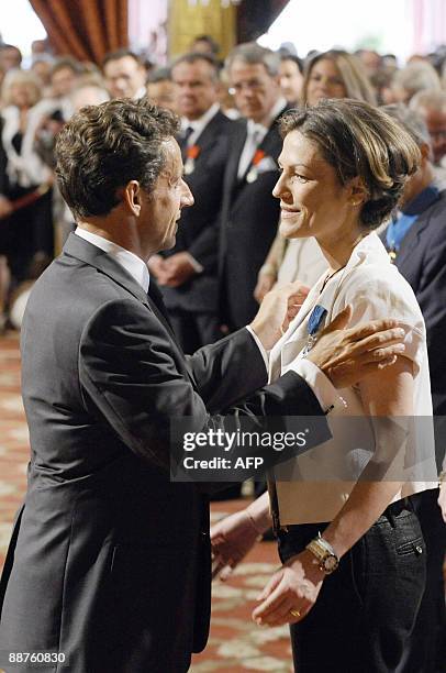 French president Nicolas Sarkozy awards French deputy minister for Ecology Chantal Jouanno chevalier de l'Ordre national du Merite on June 30, 2009...