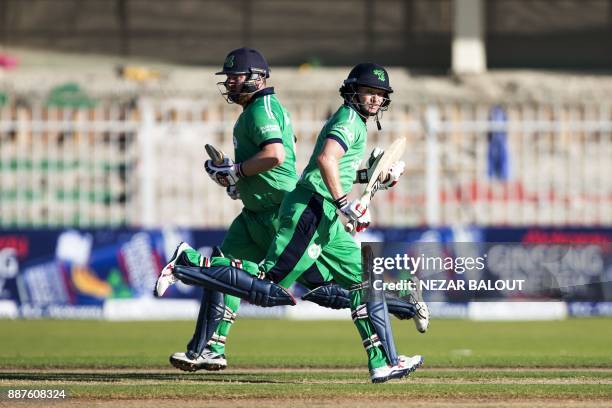 Ireland's bastmen William Porterfield Paul Stirling run between the wickets during 2nd one day international cricket match between Afghanistan and...