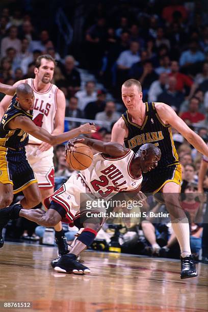 Michael Jordan of the Chicago Bulls drives against Rik Smits of the Indiana Pacers in Game Two of the Eastern Conference Finals during the 1998 NBA...