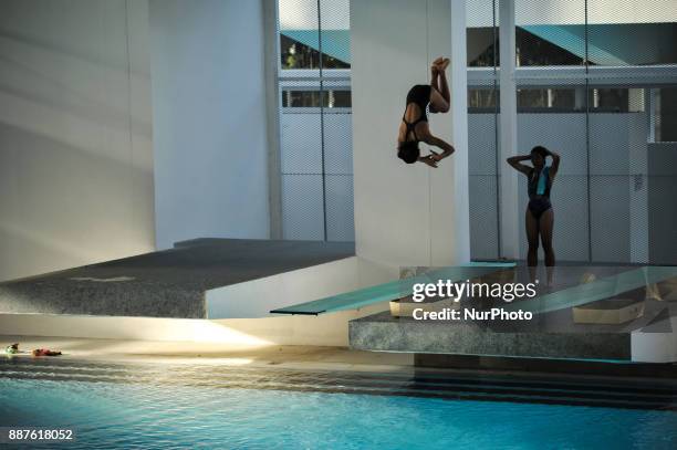 An athlete jumps as she practices before join Indonesia Open Aquatic Championship at the renovated Aquatics Stadium in Gelora Bung Karno sporting...