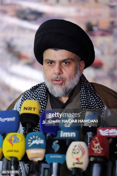 Iraq's powerful Shiite cleric Moqtada al-Sadr addresses the media with a giant photo of Jerusalem's Dome of the Rock mosque in the background in the...