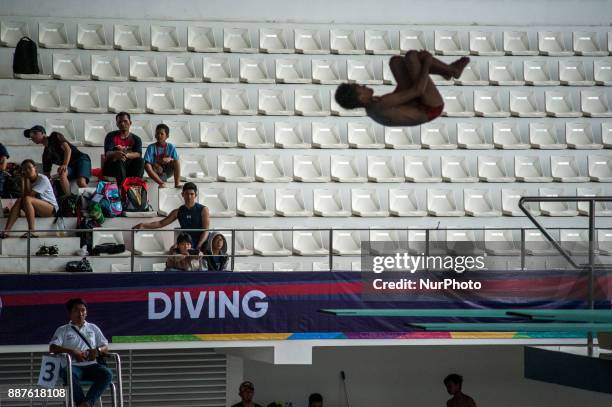 An athlete jumps in Indonesia Open Aquatic Championship at the renovated Aquatics Stadium in Gelora Bung Karno sporting complex, Senayan in Jakarta,...