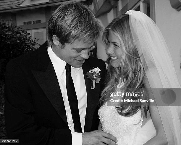 Newlyweds Brad Pitt and Jennifer Aniston pose for pictures Saturday, July 29 in Malibu, Calif.