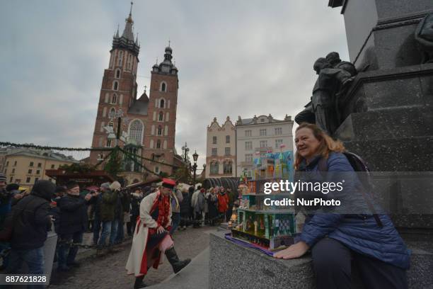 People pose in front of Nativity Scenes on display in Krakow's Main Square, during the 75th Nativity Scene Contest. On Thursday, 7 December 2017, in...