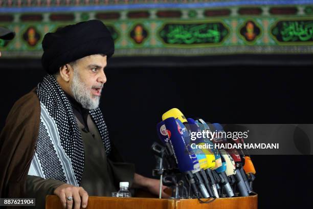 Iraq's powerful Shiite cleric Moqtada al-Sadr addresses the media with a giant photo of Jerusalem's Dome of the Rock mosque in the background in the...