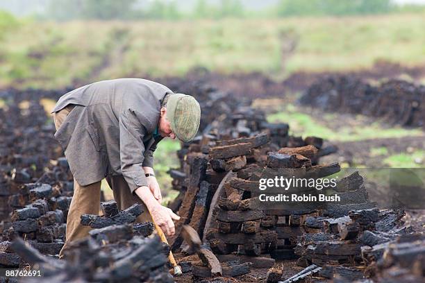 turning the peat sods, central bogland near birr, ireland - bog stock pictures, royalty-free photos & images