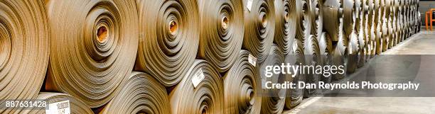 stacked carpet rolls as abstract - perspectiva de una cinta transportadora fotografías e imágenes de stock