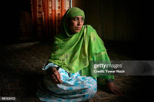 Zaina Begum 44, poses for a picture inside her house on June 30, 2009 on the outskirts of Srinagar in the Indian Administered Kashmir. Zaina 44, says...