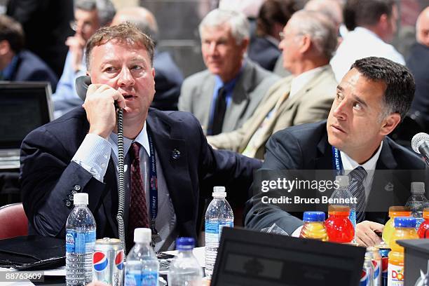 General Manager Mike Gillis and assistant General Manager Laurence Gilman of the Vancouver Canucks sit at the draft table during the 2009 NHL Entry...