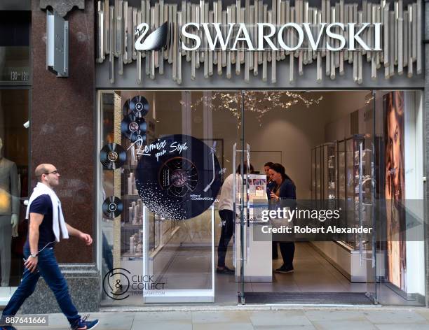 Customers shop at a Swarovski jewelry and decorative accessories shop in London, England.