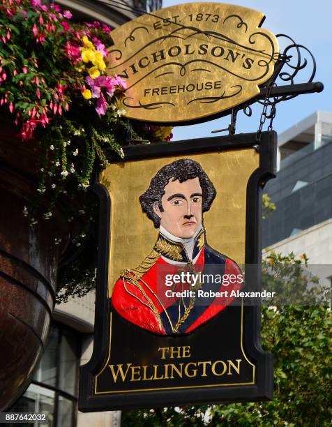 Sign hangs over the entrance to The Wellington pub in the Covent Garden district of London, England. The pub is named after Arthur Wellesley, Duke of...