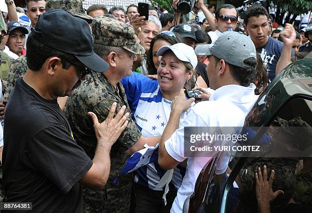 Honduran top military chief General Romeo Vasquez is greeted by a sympathizer during a rally against ousted president Manuel Zelaya at Morazan Square...