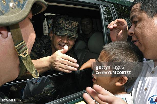 Honduran top military chief General Romeo Vasquez greets a sympathizer as he leaves a rally against ousted president Manuel Zelaya at Morazan Square...