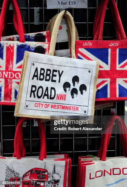 Souvenir tote bags for sale in a London, England, shop are imprinted with British flags and photographs of The Beatles with the name of the London...