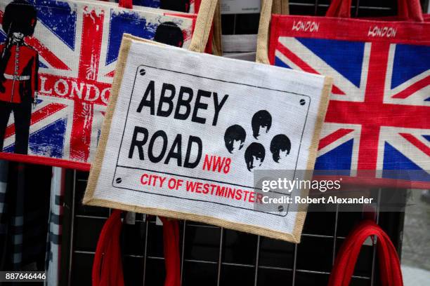 Souvenir tote bags for sale in a London, England, shop are imprinted with British flags and photographs of The Beatles with the name of the London...