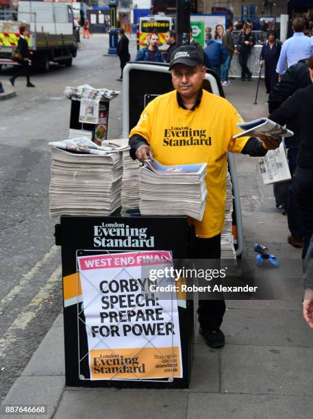 London Evening Standard newspaper distributor hands out copies of the newspaper in front of London Victoria train station in London, England. The...