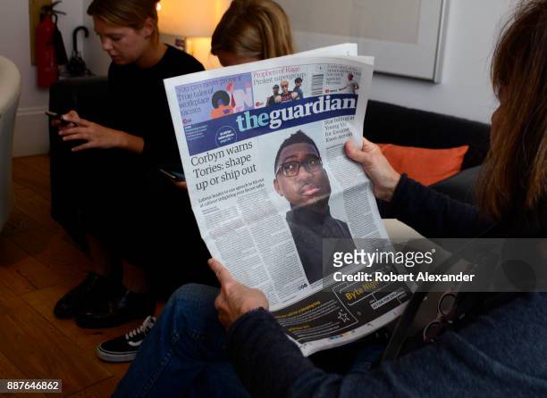 Tourist reads a copy of The Guardian newspaper in the lobby of a hotel in London, England. The Guardian is a British daily newspaper, part of the...