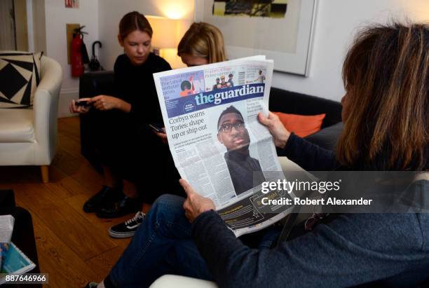 Tourist reads a copy of The Guardian newspaper in the lobby of a hotel in London, England. The Guardian is a British daily newspaper, part of the...