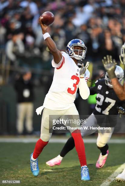 Geno Smith of the New York Giants throws a pass against the Oakland Raiders during their NFL football game at Oakland-Alameda County Coliseum on...