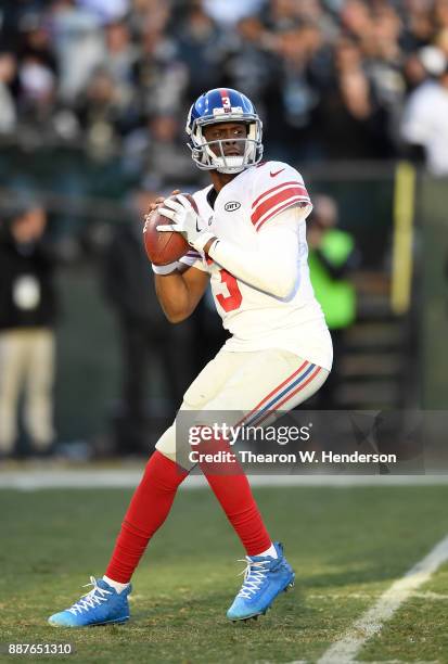 Geno Smith of the New York Giants drops back to pass against the Oakland Raiders during their NFL football game at Oakland-Alameda County Coliseum on...