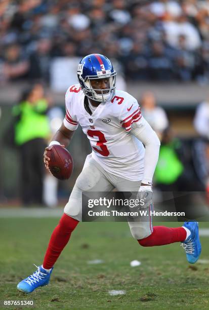 Geno Smith of the New York Giants rolls out to pass against the Oakland Raiders during their NFL football game at Oakland-Alameda County Coliseum on...