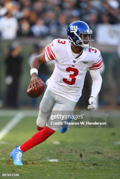 Geno Smith of the New York Giants rolls out to pass against the Oakland Raiders during their NFL football game at Oakland-Alameda County Coliseum on...