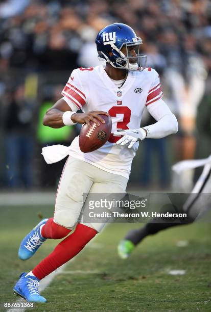 Geno Smith of the New York Giants rolls out to pass against the Oakland Raiders during their NFL football game at Oakland-Alameda County Coliseum on...