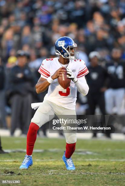 Geno Smith of the New York Giants drops back to pass against the Oakland Raiders during their NFL football game at Oakland-Alameda County Coliseum on...