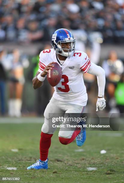Geno Smith of the New York Giants rolls out to pass against the Oakland Raiders during their NFL football game at Oakland-Alameda County Coliseum on...